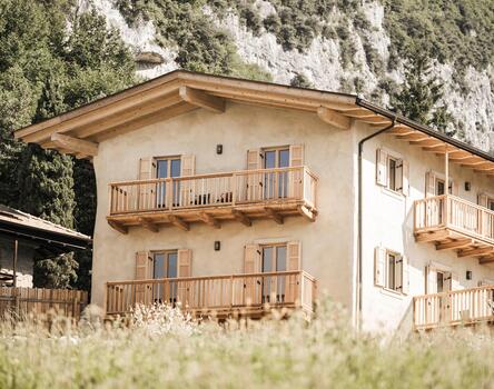Gesamtansicht des sanierten Wohnhauses in Tenno mit Fenstern und Jalousien aus Holz